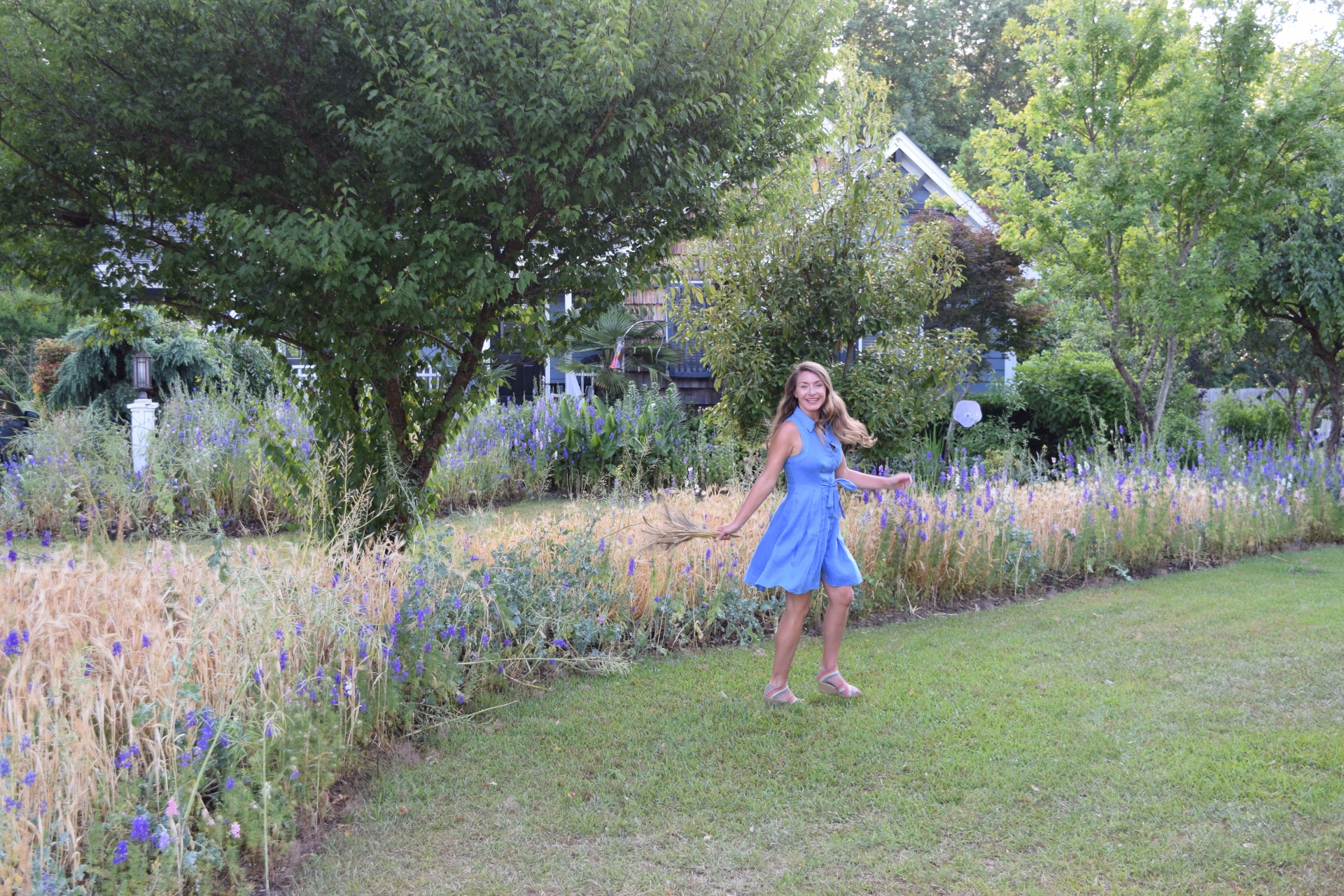 woman in dress twirling in garden